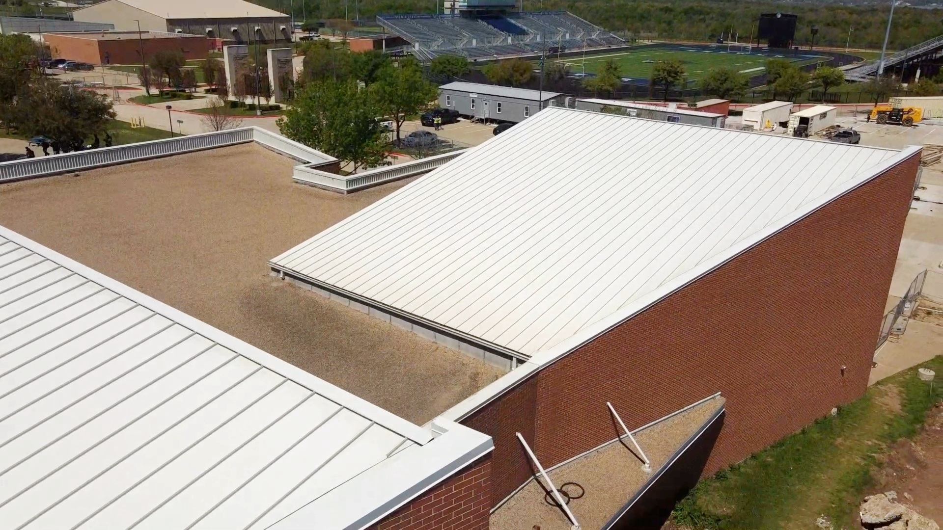 Standing seam metal roof on a brick school building