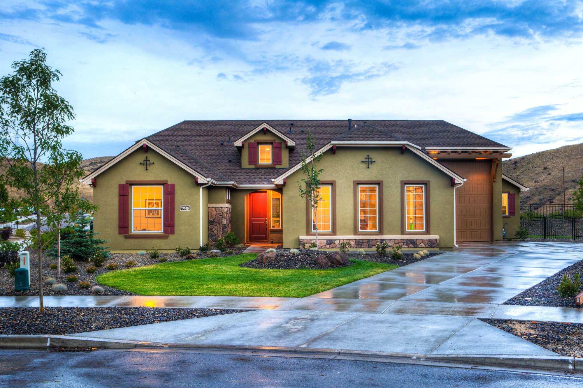 Shingle roof on a craftsman home with stone accents at dusk