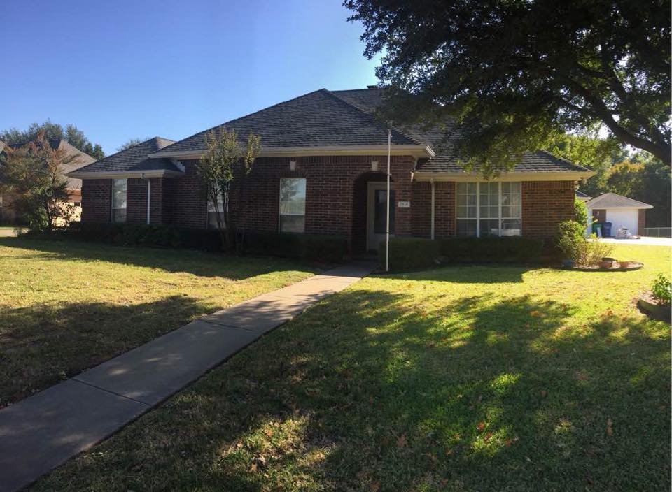 New dark architectural shingle roof on a brick ranch home