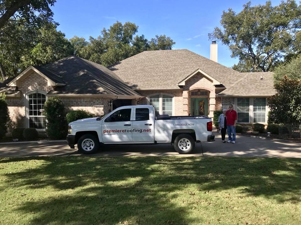 Residential re-roof in progress with the Premiere Roofing crew and truck on site